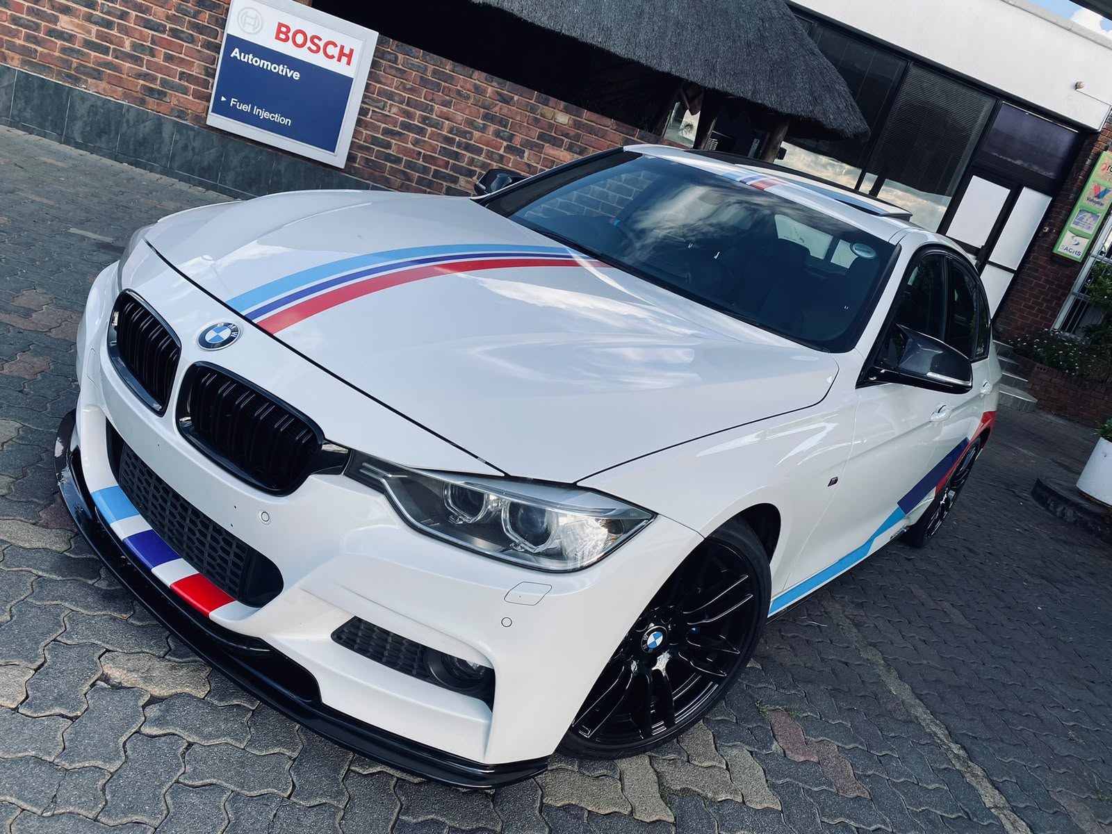 White BMW 3 Series with M stripes at Hi-Tech Auto Centre in Norkem Park